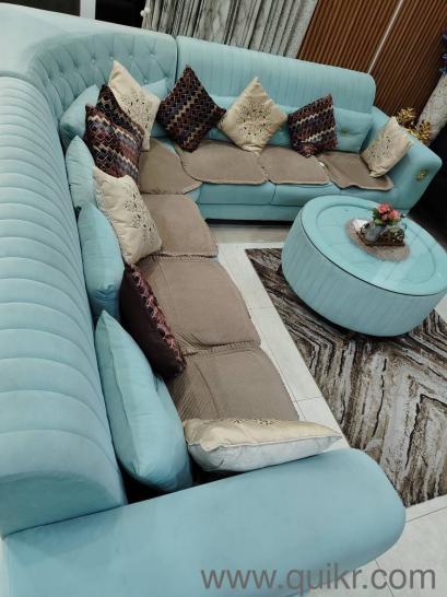 L shape sea green sofa along with central round table(2)