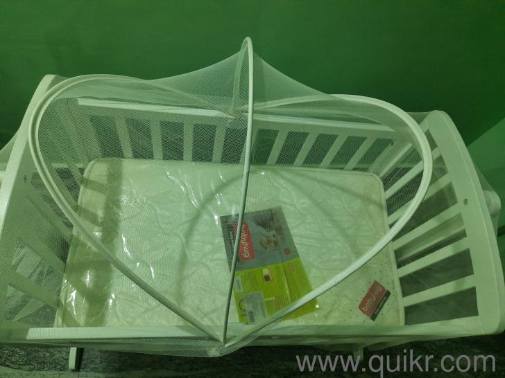 Babyhug baby cradle with Mosquito net and a new babyhug baby mattress