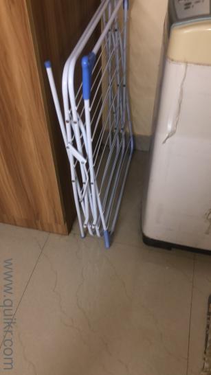 Second hand washing machine but clean working properly along cloth hanger
