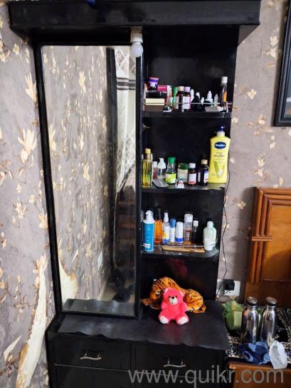 dressing table with storage behind the mirror. also has open storage with 4 cabinets at bottom