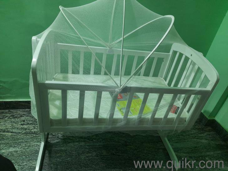 Babyhug baby cradle with Mosquito net and a new babyhug baby mattress